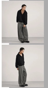 Detailed view of striped wide-leg trousers and black hoodie for a relaxed urban outfit