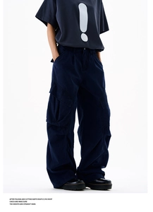 Detail of dark blue cargo pants with side pockets and a relaxed straight-leg high street fit