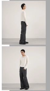 Detailed side view of dark grey striped wide-leg trousers and white long sleeve top