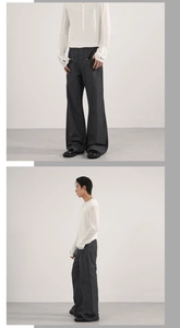 Detailed view of dark grey vertical striped wide-leg trousers with elegant drape