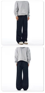Front and back view of men's black loose-fit cargo pants with large flap side pockets