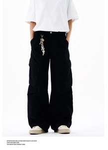 Close-up of black cargo pants featuring wide-leg design and metal keychain detail
