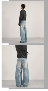 Detail of light blue wide-leg jeans with vintage washed texture and rear pocket view