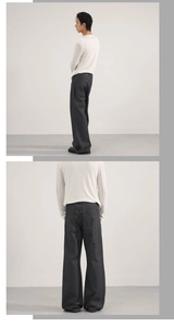 Detailed view of men's dark gray pinstripe wide-leg trousers with vertical texture
