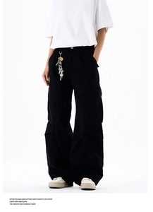 Detailed view of high waist black wide leg cargo pants with multi-pocket utility design