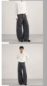 Dettaglio dei pantaloni cargo larghi grigio antracite con rivetti e cuciture di stile