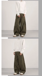 Detail of olive green vintage workwear trousers with curved silhouette and patchwork seams