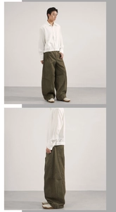 Detail of military green baggy cargo pants with vintage paneling and wide leg silhouette