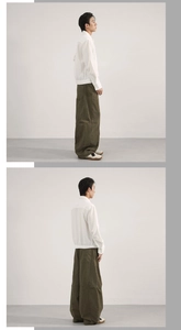 Detail view of olive green oversized curved cargo pants with minimalist white jacket outfit