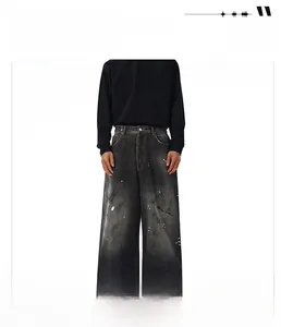 Detail of high-end vintage washed black denim with distressed textures and cat whiskers