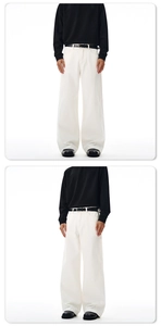 Close-up of high-waist white wide-leg cotton pants with a black leather belt