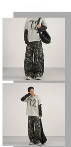 Detail of baggy cargo pants featuring all-over star print and multiple large side pockets