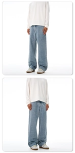 Detail of light blue wide-leg jeans featuring a vintage washed ink splatter design for men