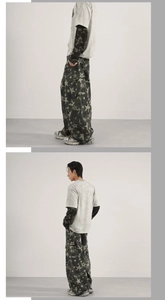 Detail view of baggy cargo pants with star prints and washed grey t-shirt in street style