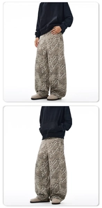 Dettaglio dei pantaloni baggy in denim leopardato e felpa con cappuccio stile street
