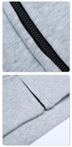 Detail shot of black zipper closure and ribbed hem on grey knit hoodie jacket