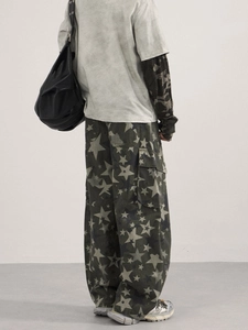 Deep green baggy cargo pants with all-over star print and relaxed streetwear aesthetic