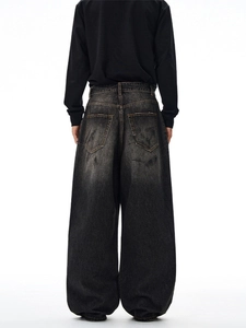 Oversized black washed denim jeans with contrast stitching and wide-leg streetwear fit