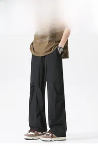 Detail of breathable ice silk fabric on black loose fit cargo pants with drawstring waist