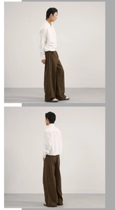 Detail showing the vertical patchwork seams of loose fit brown wide-leg trousers