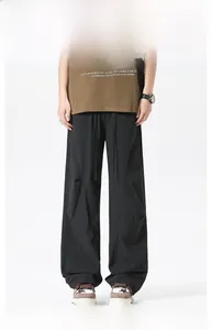 Detail of black ice silk paratrooper pants with drawstring waist and cargo stitching
