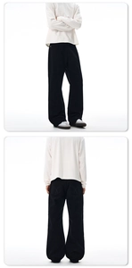 Dettaglio dei pantaloni flare neri high-street che mostra il taglio ampio e il drappeggio