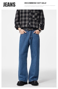 Detail of baggy dark blue jeans featuring classic wash and premium fabric texture