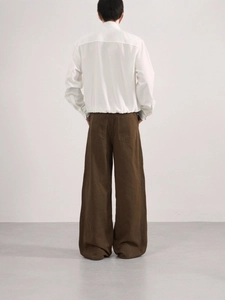 Back view of men's white long sleeve shirt and oversized dark brown wide leg trousers