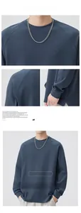 Detail view showing high-density slate blue sweatshirt fabric with split hem and shoulder seams