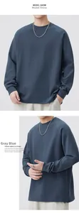 Detail of gray-blue crewneck sweatshirt featuring raglan sleeves and ribbed cuffs for men