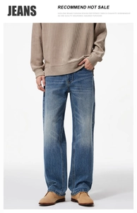 Detail of men's straight-leg blue jeans featuring natural whiskering and washed texture