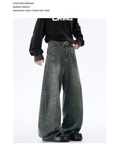 Detail of vintage washed wide-leg denim jeans with retro fading and streetwear styling