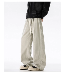 Close-up of drawstring elastic waistband on men's oversized beige cotton casual pants