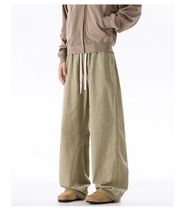 Detailed close-up of olive green cotton drawstring trousers with premium fabric texture