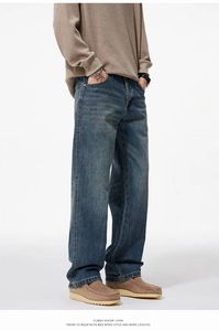 Détail d'un jean bleu vintage à coupe droite pour homme avec texture délavée et poches