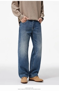Close-up of men's wide-leg straight denim jeans in classic washed blue finish