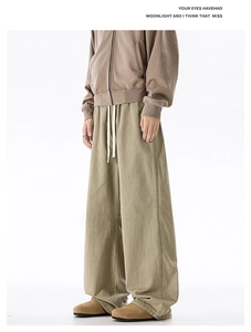 Detail view of khaki cotton straight-leg cargo pants with white adjustable drawstrings