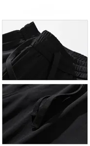 Detail view of elastic drawstring waistband on black quick-dry tech pants