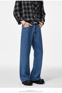 Detail of dark blue baggy jeans with classic contrast stitching and wide-leg fit for men