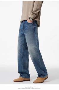 Side view of men's blue straight leg jeans featuring natural washed texture and denim fabric