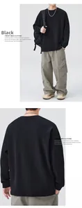 Front and back view of men's black crewneck sweatshirt and olive cargo pants set