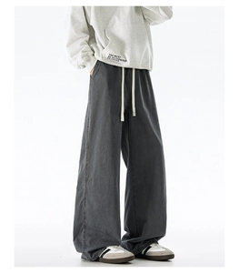 Macro detail of dark grey wide-leg cotton pants with elastic waist and drawstring