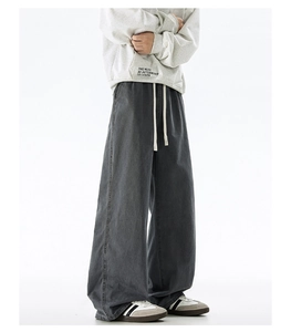 Detail shot of men's dark grey wide leg cotton trousers with elastic drawstring waist