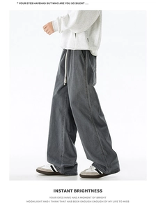 Detail of dark grey washed cotton oversized street pants with white drawstring waist