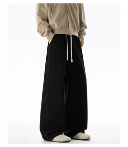Detail of black cotton straight-leg trousers with elastic drawstring waist for men