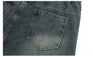 Detail of rear pocket on vintage wash blue denim jeans with durable double stitching