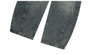Detail of vintage washed blue wide leg jeans with stitched panels and denim texture