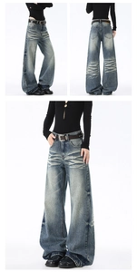 Dettaglio dell'effetto vintage e baffature sui jeans in denim a gamba larga