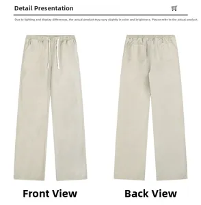 Flat lay of beige cotton straight-leg trousers with elastic waist and drawstring