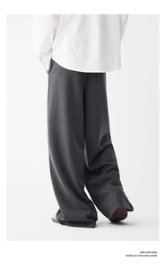 Rear view of dark grey striped wide-leg trousers showing smooth drape and loose fit